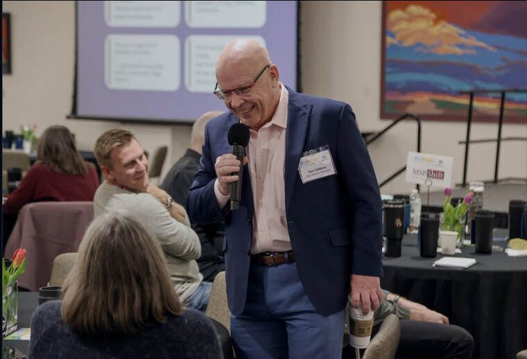 Paul Gibbons laughing with executives during a workshop keynote